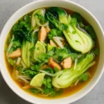 Hearty Bok Choy Chicken Soup in bowl with bok choy and chicken