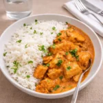 Crockpot Butter Chicken served over rice with cilantro garnish