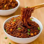 Easy Saucy Ramen Noodles in a bowl with sesame and scallions