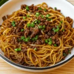 Mongolian Ground Beef Noodles in bowl with sesame seeds