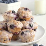 Baked Blueberry Fritter Bites on breakfast table with blueberry glaze