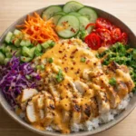 Bang Bang Chicken Bowl with spicy creamy sauce and vegetables