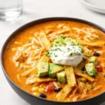 Easy Chicken Tortilla Soup garnished with tortilla strips and avocado