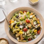 Zesty Italian Pasta Salad in a bowl with fresh vegetables