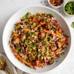 A vibrant bowl of Asian Chicken Crunch Salad with peanut dressing