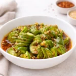 Asian Cucumber Salad TikTok spirals in a white bowl with sesame seeds