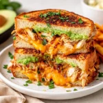 Crispy Chicken Avocado Melt Sandwich with melted cheese and sourdough bread