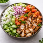 A colorful Chicken Shawarma Bowl with grilled chicken and tahini sauce.