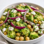 Fresh Chickpea Feta Avocado Salad in a white bowl on a wooden table