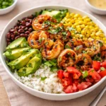 A colorful Chipotle Lime Shrimp Bowl with avocado and rice.
