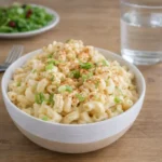 Deviled Egg Pasta Salad in bowl with paprika and green onions