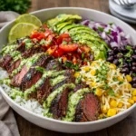 A colorful Easy Cilantro Lime Steak Bowl with avocado and charred corn.