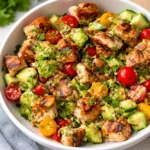 Fresh Avocado Chicken Salad in a wooden bowl with lime