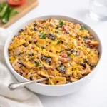 Frito Corn Salad in a white bowl on a wooden table