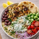 A vibrant Greek Chicken Gyro Bowl with grilled chicken, veggies, and tzatziki sauce.