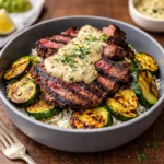 A delicious Grilled Steak Bowl with Sauce featuring sliced beef and charred zucchini.