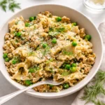 herby spring pasta salad with protein served in bowl