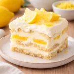 A layered Lemon Tiramisu garnished with lemon slices and mint.