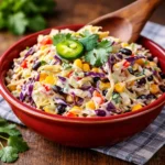 A bowl of Zesty Mexican Coleslaw in Minutes with charred corn and black beans.