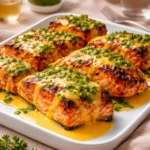 A platter of cooked Bang Bang Salmon with spicy glaze and green onions.