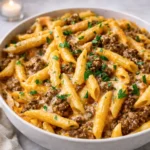 Creamy High Protein Beef Pasta in a white bowl on a wooden table