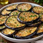 Crispy Oven-Baked Eggplant slices on a white plate with marinara sauce.