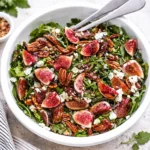 Fresh Fig Salad with Arugula and Pecans in a wooden bowl