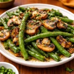 Garlic Butter Sautéed Green Beans and Mushrooms in a skillet.