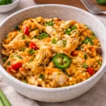 Jalapeño Buffalo Chicken Casserole in a white baking dish drizzled with ranch.