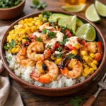 A vibrant Mexican Street Corn Shrimp Bowl with avocado and lime.