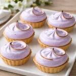 Mini Lemon Tart with Lilac Meringue on a wooden table