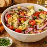 Tuscan Artichoke Tomato Salad in a rustic bowl